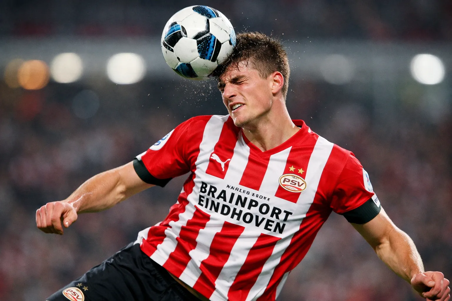 A recognizable representation of Wouter Goes, a young and tall defender, wearing a PSV Eindhoven home kit in a defensive action pose winning a header.