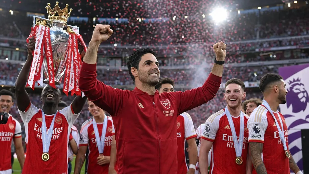 Mikel Arteta celebrates Arsenal's Premier League title win with players holding the trophy under stadium floodlights