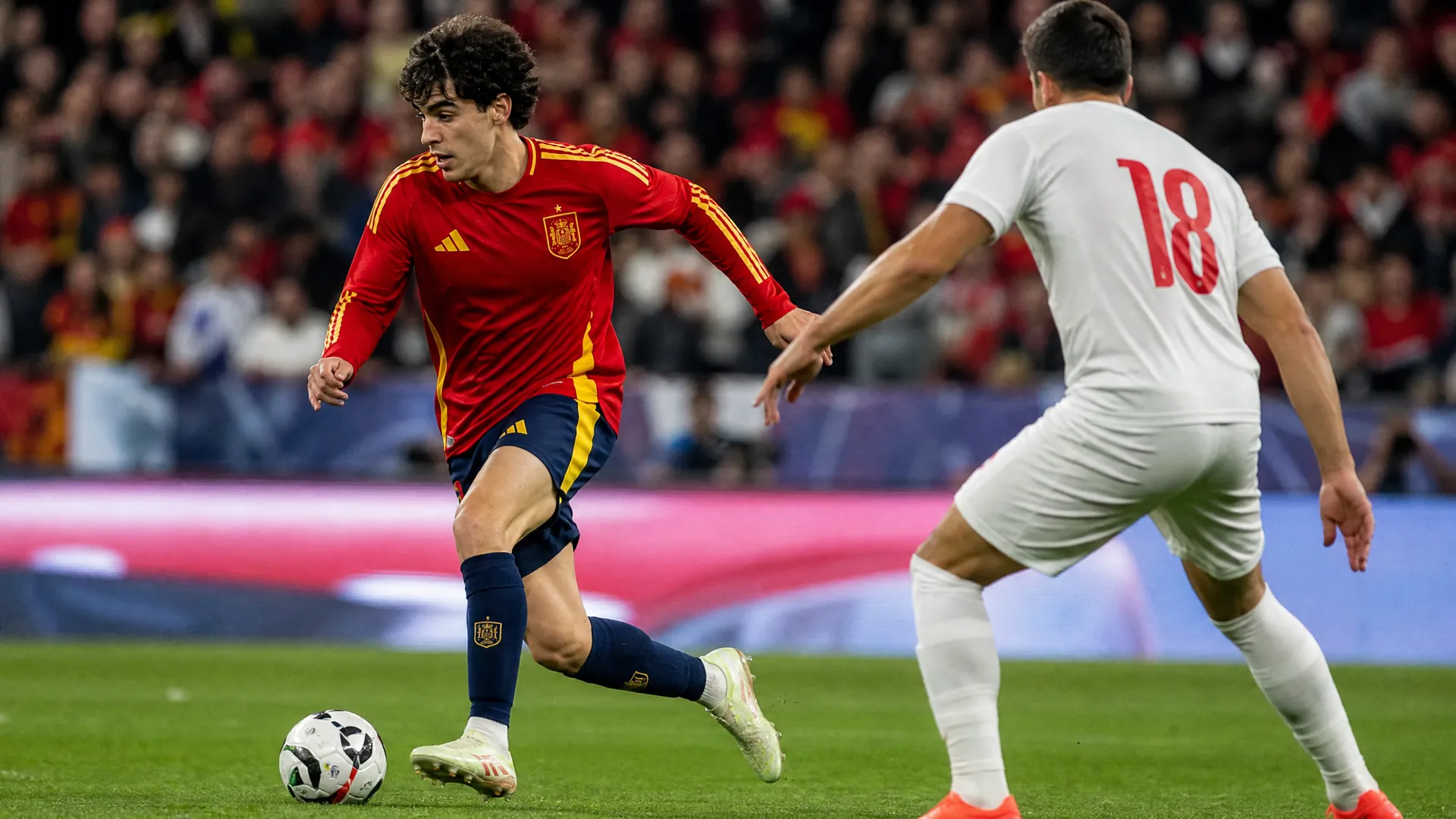 Lamine Yamal dribbling in Spain's red national team kit as the Barcelona teenager prepares for the 2026 World Cup