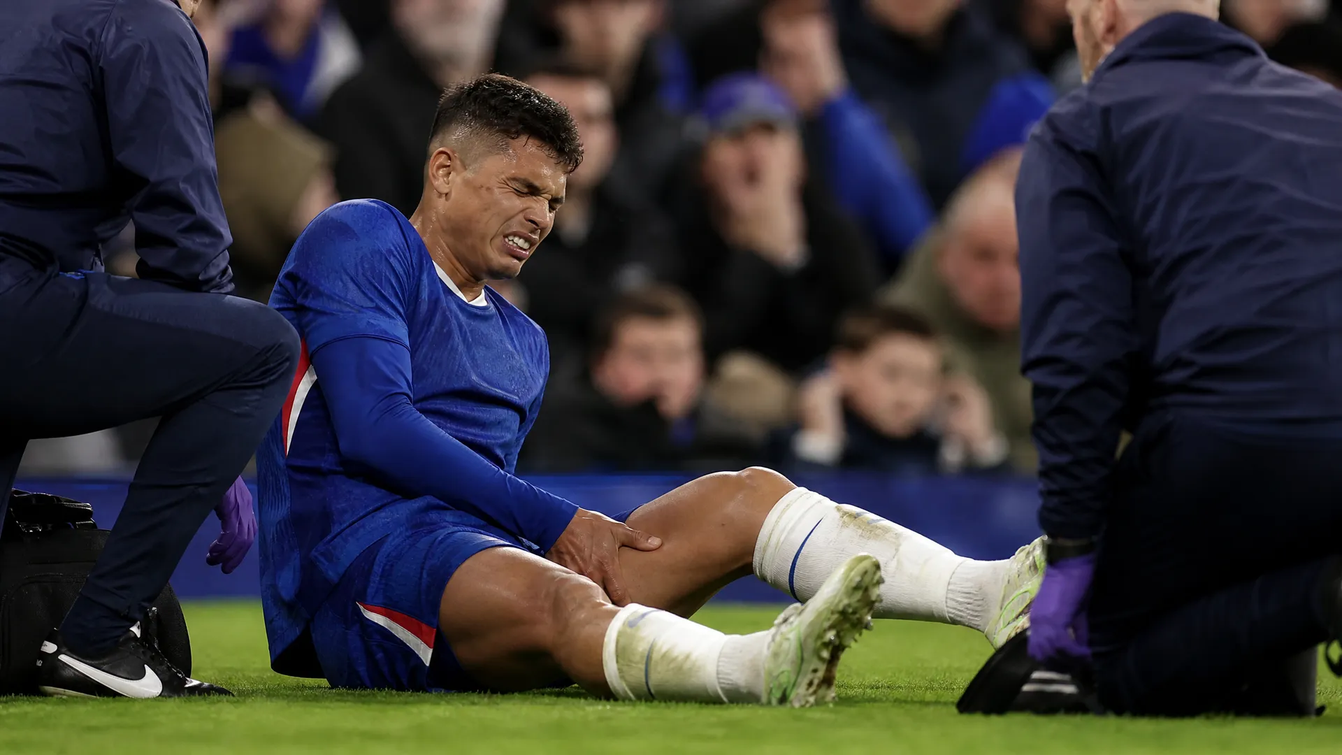 Estevao Willian clutching his hamstring injury in Chelsea's blue kit, ruling him out of Brazil's 2026 World Cup squad