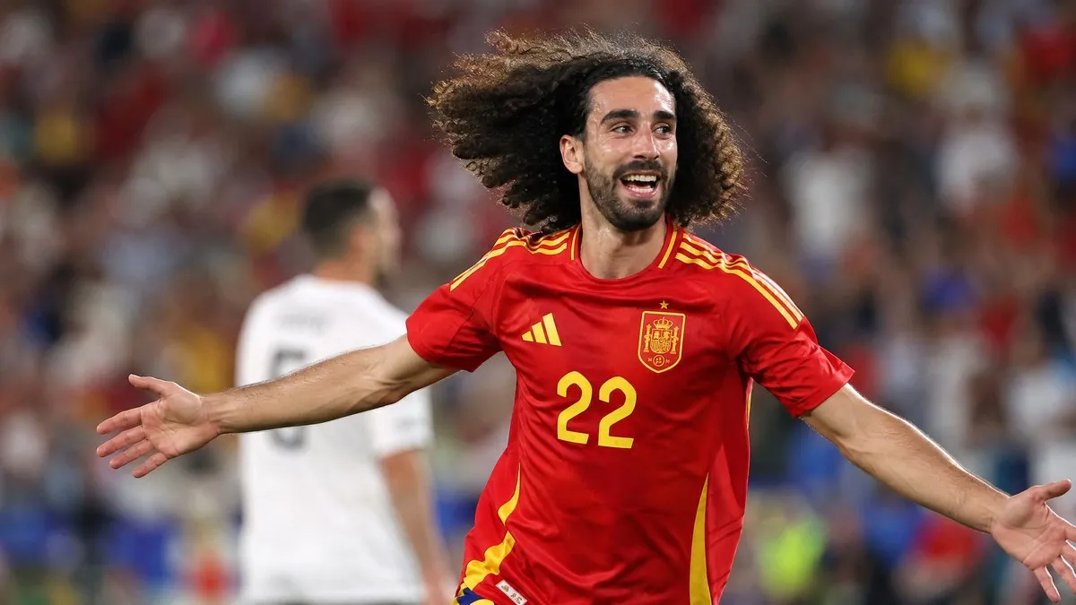 Marc Cucurella celebrating in Spain's red kit with his iconic curly hair flowing at the World Cup 2026