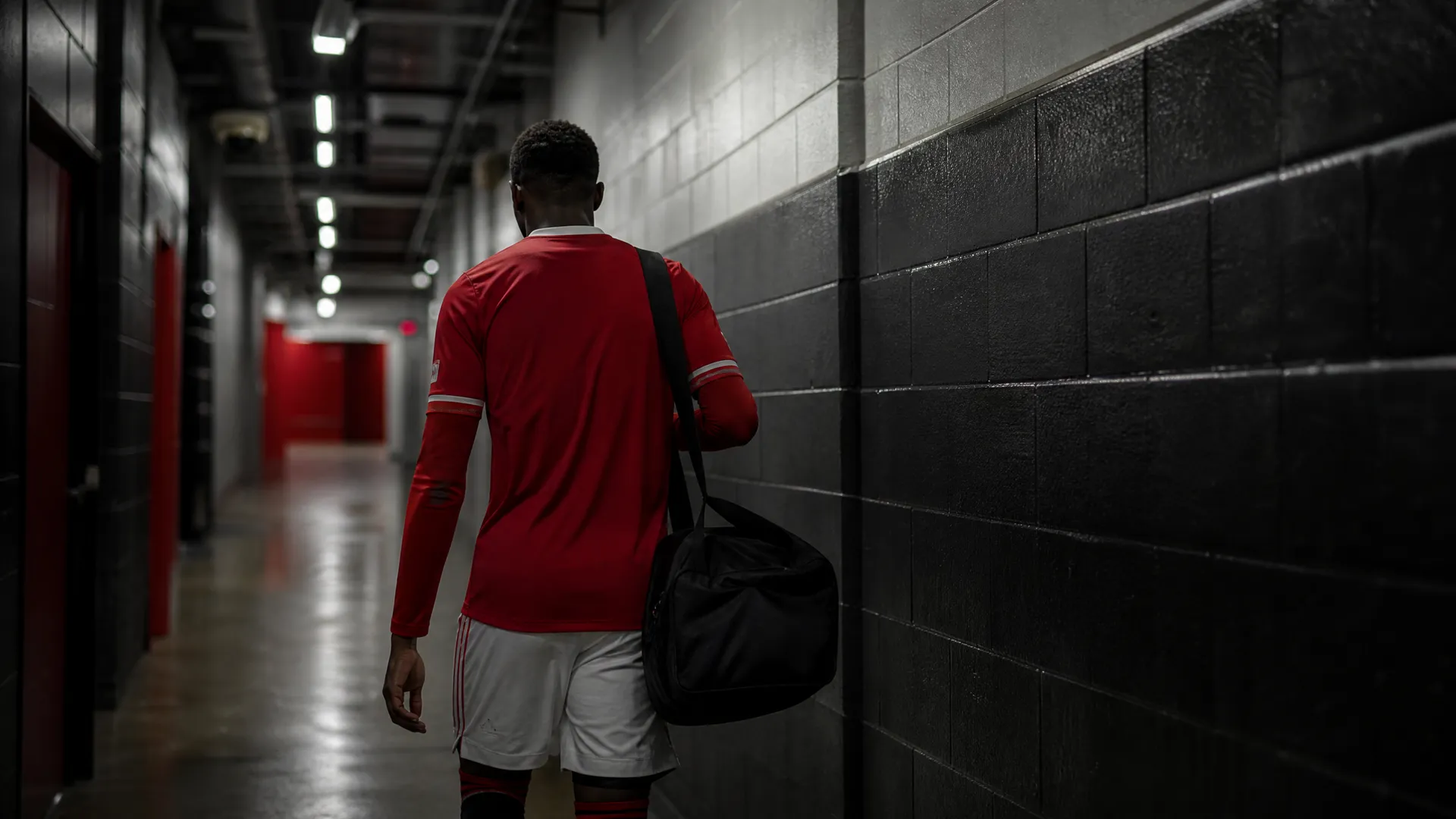 Manchester United player walking away through a stadium tunnel as Sancho, Casemiro and Malacia depart the club