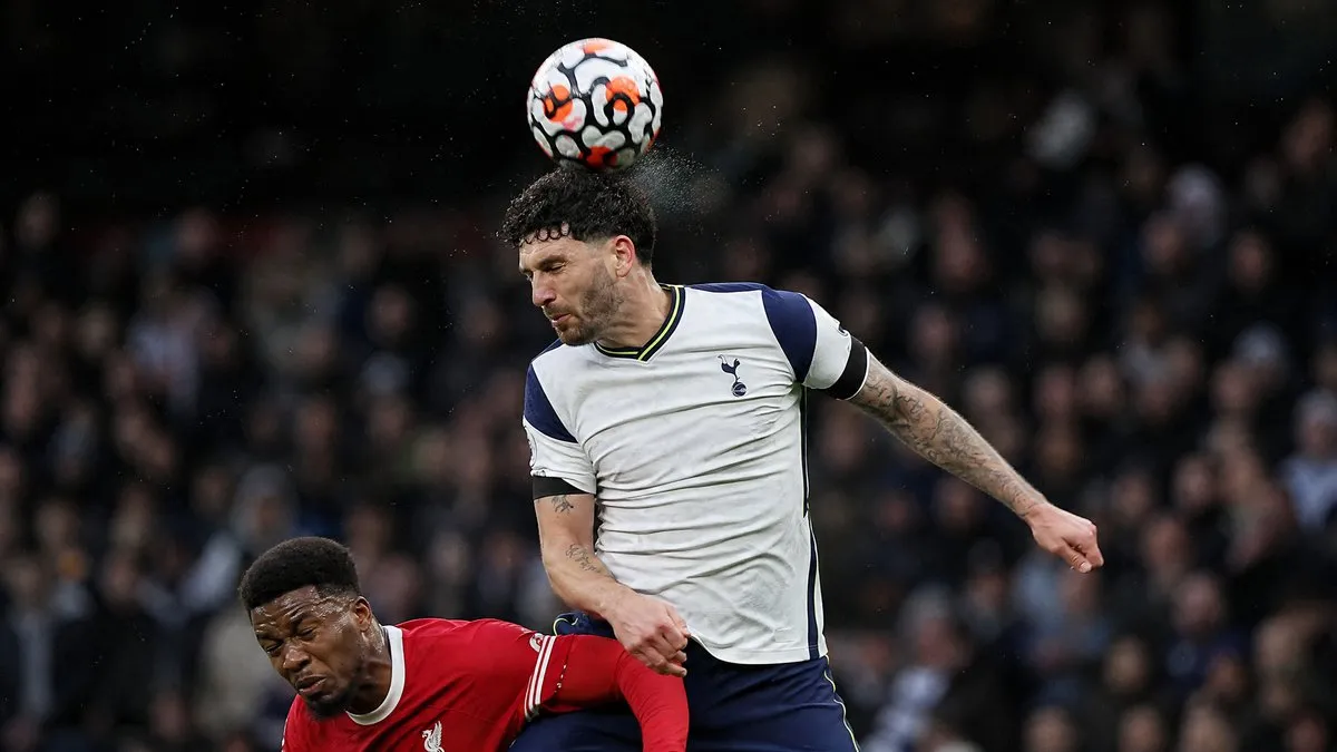 Marcos Senesi winning a header in Tottenham Hotspur's white kit after completing a free transfer from Bournemouth to Spurs