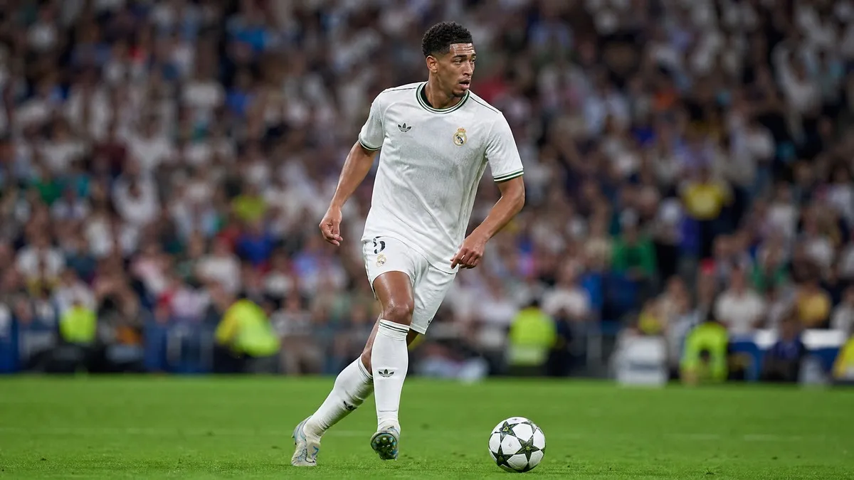 Trent Alexander-Arnold in a white Real Madrid kit, in action on the pitch at the Santiago Bernabeu, focused and determined.